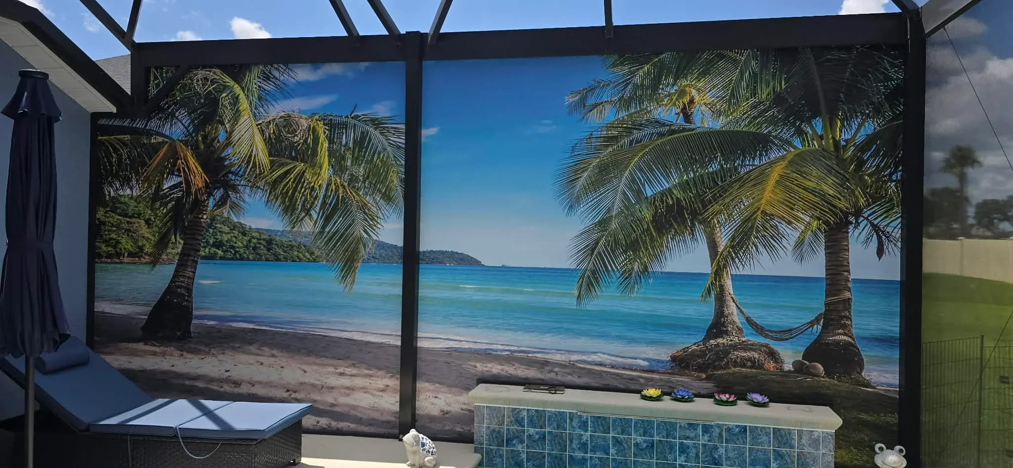 Black aluminum screen frame with large tropical beach vinyl graphics and palm tree imagery