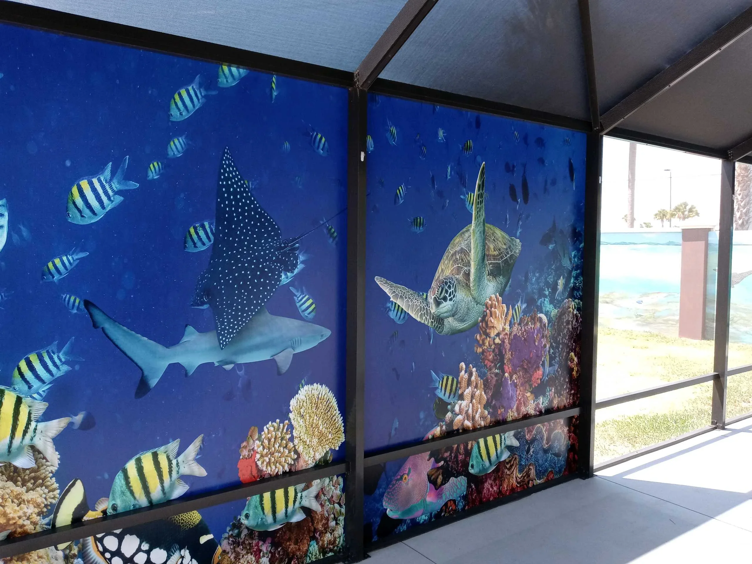 Custom printed marine mural screens with sea turtles, manta rays, and tropical fish on black aluminum frames